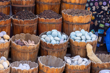 Street bazaar on an Egyptian street with colored natural pumice stones, dried flowers and leaves of...