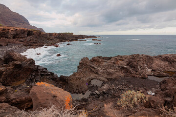 Stone coast with cliffs of the Atlantic Ocean at sunrise. Tenerife. Canary Islands, Spain