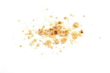 Ground, milled, crushed or granulated hazelnut pile isolated on white background
