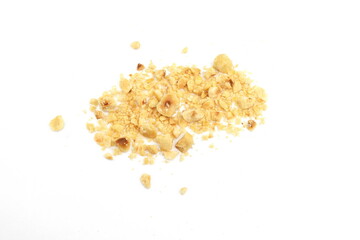 Ground, milled, crushed or granulated hazelnut pile isolated on white background