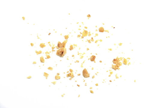 Ground, milled, crushed or granulated hazelnut pile isolated on white background
