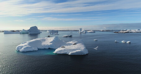 Wild Antarctic nature landscape, glaciers floating in ocean water in sunny day. Arctic winter...