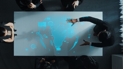 Top down aerial of business team brainstorm idea about digital communication or global network connection. Group of diverse business people discuss about data processing at meeting room. Directorate.