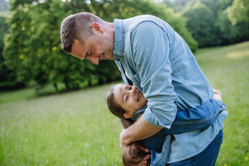 Dad with daughter, playing at meadow, hugging, having fun. Concept of fathers's Day and fatherly love. - 755137196
