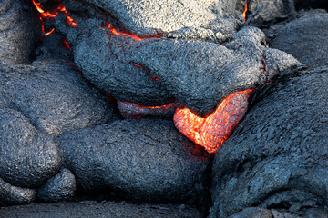 Heart shaped red glowing lava detail on lava field in Hawaii Volcanoes National Park, USA