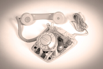 Part of a broken old telephone, phone with dial plate - plastic phone