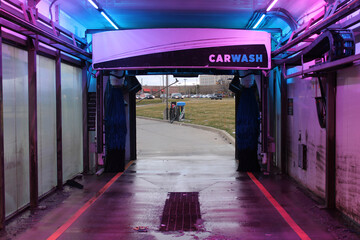 A computerized, self serve, drive thru car wash sits empty and in-between vehicle washings in...