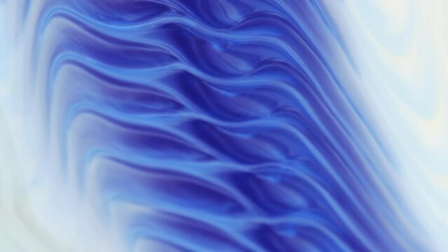 Moving natural background in the style of abstract art. The blue tone in the marble pattern. Abstract texture in white and blue tones. Flowing, ever-changing liquid abstraction, slow motion, beautiful