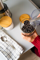 Close-up shot of the hands of an unrecognizable person in the kitchen preparing breakfast