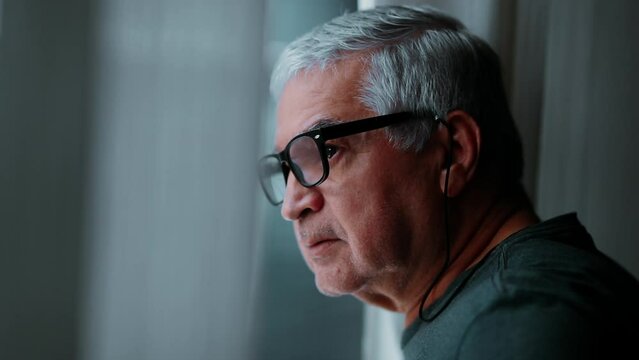 Elderly Man Reflectively Gazing Outdoors, Close-Up of Thoughtful Senior by Window at Home