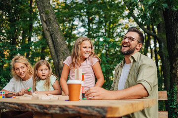 Happy parents laughing and having fun family time in nature.