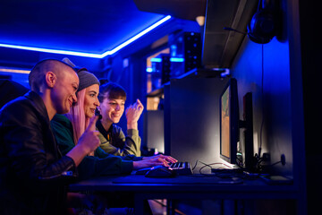 Side view portrait of a woman team of gamers playing online video games