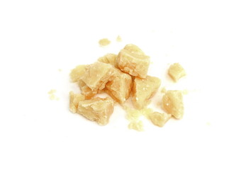 Pieces of parmesan cheese isolated on white background. Parmesan crumbs on white. 