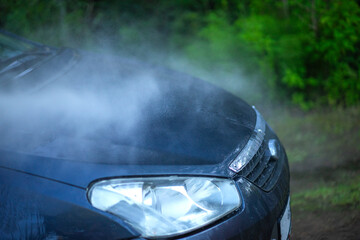 Manual car washing in nature.Wash the car on your own.Wash off the dirt with a high-pressure washer.