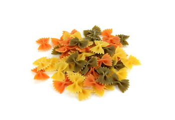 Color pasta in the form of bows. Raw farfalle with spinach and tomato isolated on a white background. High quality photo