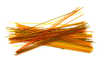 long multicolored pasta, flavoured spaghetti isolated on white background. Uncooked dry fettuccine pasta tied in a bundle isolated on a white background. Raw spaghetti. Beautiful raw spaghetti pasta.