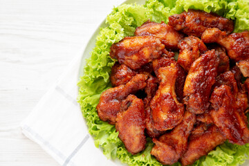 Homemade Honey BBQ Chicken Wings on a Plate, top view. Flat lay, overhead, from above. Copy space.