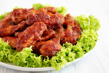 Homemade Honey BBQ Chicken Wings on a Plate, side view. Close-up.