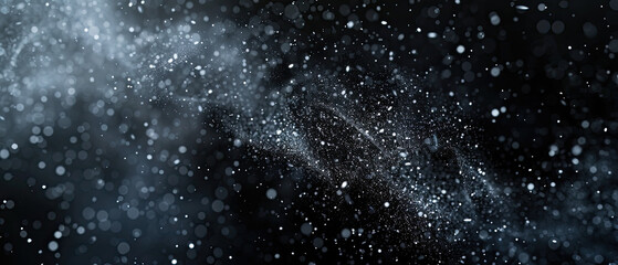 Fototapeta premium An artistic representation of a cloud of sparkling particles scattered across a dark, black background, resembling a galaxy or night sky
