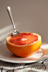 Half of fresh grapefruit on a plate with a spoon. Healthy lifestyle. - 755176917