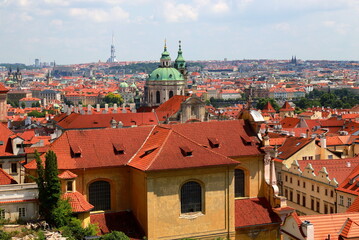 Fototapeta na wymiar Prague, Czech Republic. Mala Strana, Old Town of Prague. Top view panorama. Ancient old buildings with red tiled roofs, church, tower, castle