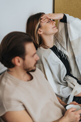 Fototapeta premium Lovely woman leaning her head on the wall, massaging her eyes and forehead during break from work at the office.