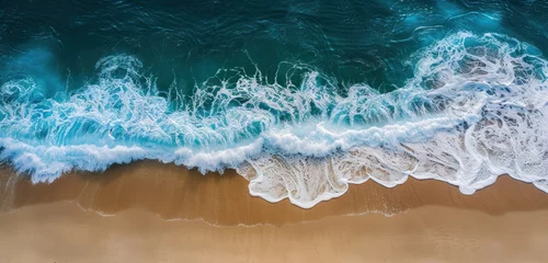 Fotobehang overhead view of ocean waves meeting a golden sandy shore © Klay
