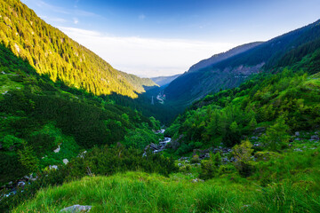 valley of carpathian mountains in morning light. beautiful landscape of fagaras range of romania on a sunny summer day