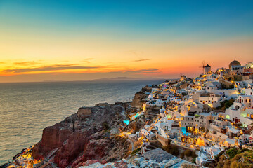 Greece vacation background. Famous iconic Oia village with traditional white houses and windmills...
