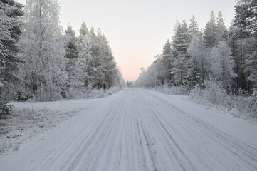Forest road covered in ice and snow in Finland