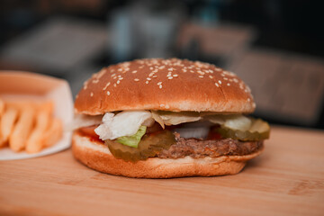 classic American meal: a mouthwatering burgerwith no cheese and crispy fries served in a bustling restaurant setting