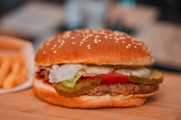 classic American meal: a mouthwatering burgerwith no cheese and crispy fries served in a bustling restaurant setting
