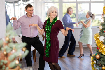 Elderly woman paired middle-aged man and spins to rhythm move are in shove of boogie woogie during...