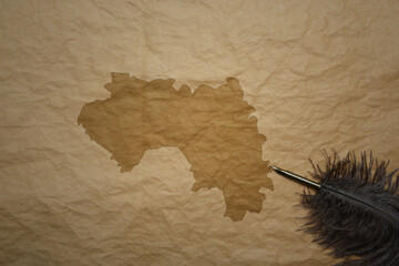 map of guinea on a old paper background with old pen