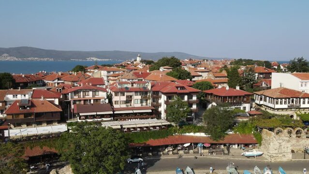 Historic old houses with red tiled roofs, architecture on Black Sea coast. Old town of Nessebar, Bulgaria, Panorama. Beautiful and colorful amazing city