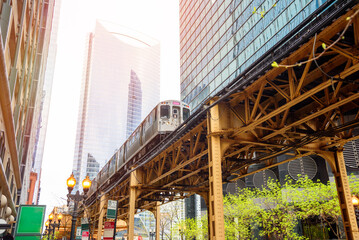 Elevated commuter train running through Chicago Loop downtown district on a spring day