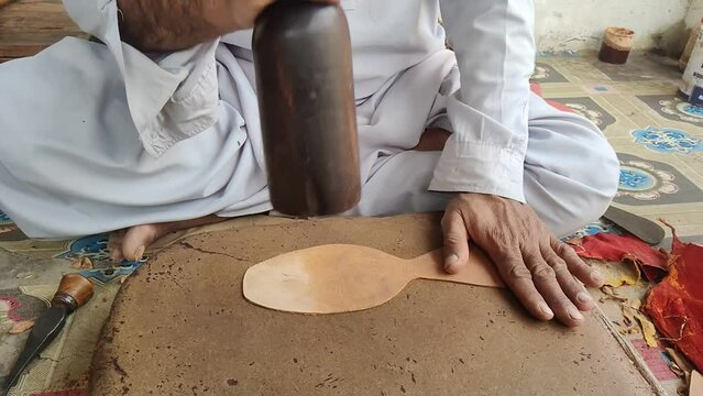 A Shoemaker is Making Shoe Sole in Pakistan