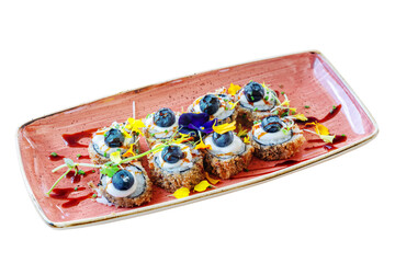 Traditional Japanese dish hot sushi Philadelphia fried in a plate decorated with flower petals. On white isolated background.