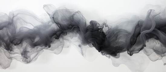 Black smoke is seen floating in the air against a clean white backdrop. The smoky wisps blend into the white space, creating a striking contrast. - obrazy, fototapety, plakaty