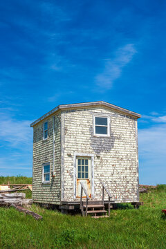 A shabby and deserted shack in North Rustico harbor, on the Gulf of Saint Lawrence shores of Prince Edward Island, Canada. Weathered shingle siding.