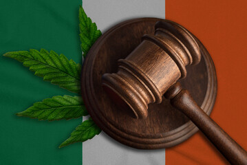 Justice wooden gavel with cannabis leaf on the Flag of Ireland. Illegal growth of cannabis plant...