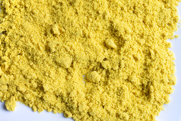 An abstract image of powered chicken soup bouillon on a white plate. 