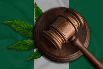 Judges gavel and hemp leaf on the Nigeria flag background. Cannabis legalization concept