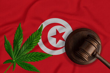 Cannabis leaf and judge gavel on the Tunisia flag background. Concept of legalization of marijuana
