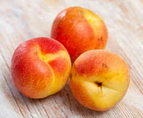 Naklejka na ściany i meble Heap of ripe reddish apricots on wooden table. Concept of health benefits of fruits.