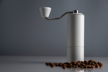 Manual coffee grinder on gray background.