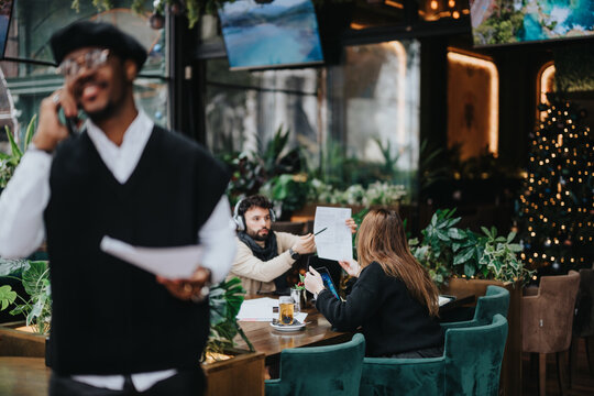 Busy entrepreneur in a stylish hat making a phone call at a cozy cafe setting. - Powered by Adobe