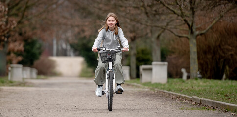 Warm Weather Sees Girl Riding Bicycle Through Spring Park - 755228797