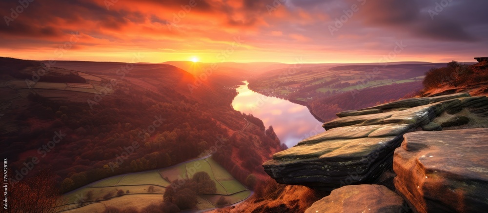 Poster the atmosphere is painted with hues as the sun sets over the river in the canyon, casting a golden g