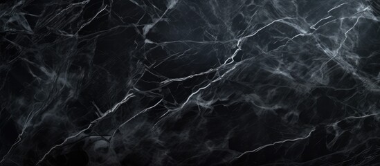 A dark and elegant black marble textured wallpaper is displayed against a sleek black background. The natural pattern of the marble adds sophistication and depth to any space it adorns.
